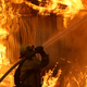 A Cal Fire firefighter battles the Camp Fire in 2018. Global warming makes deadly and destructive wildfires more likely.